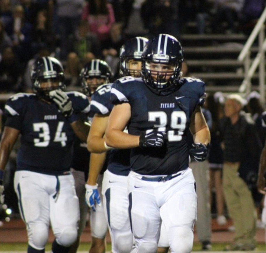 Robby in a navy Titans uniform during a college football game