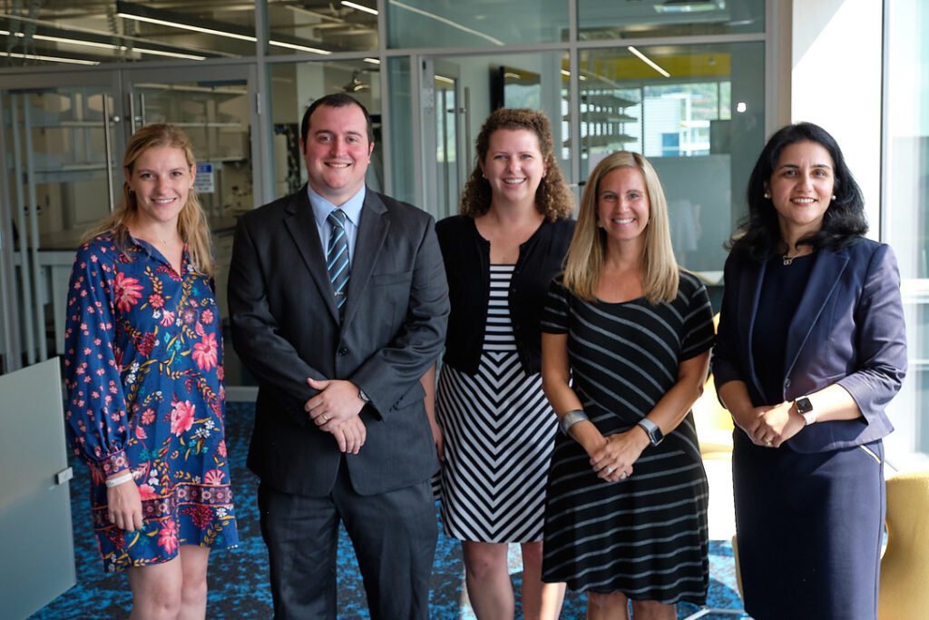 Robby with four colleagues smiling together at a UPMC Enterprises company launch
